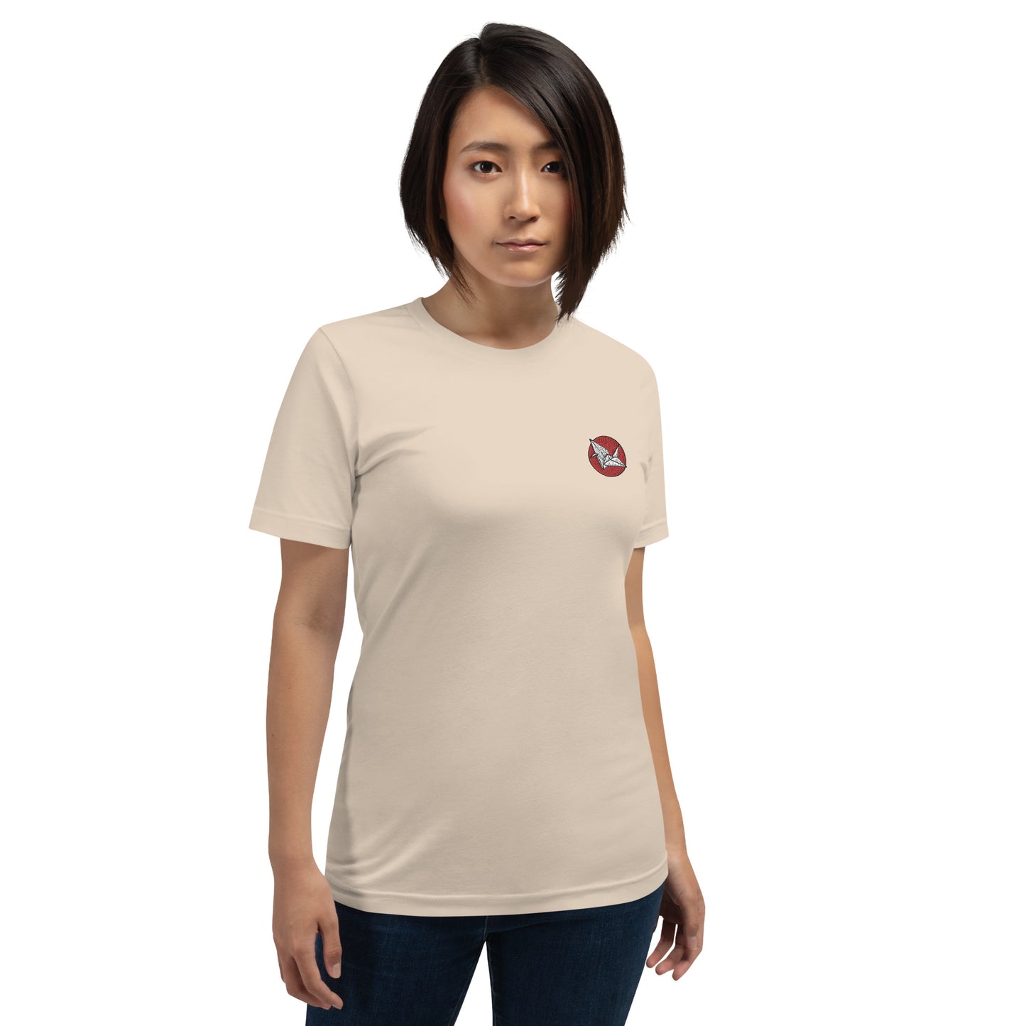  Woman wearing NOMADA Origami Crane embroidered t-shirt, Soft cream colored shirt.