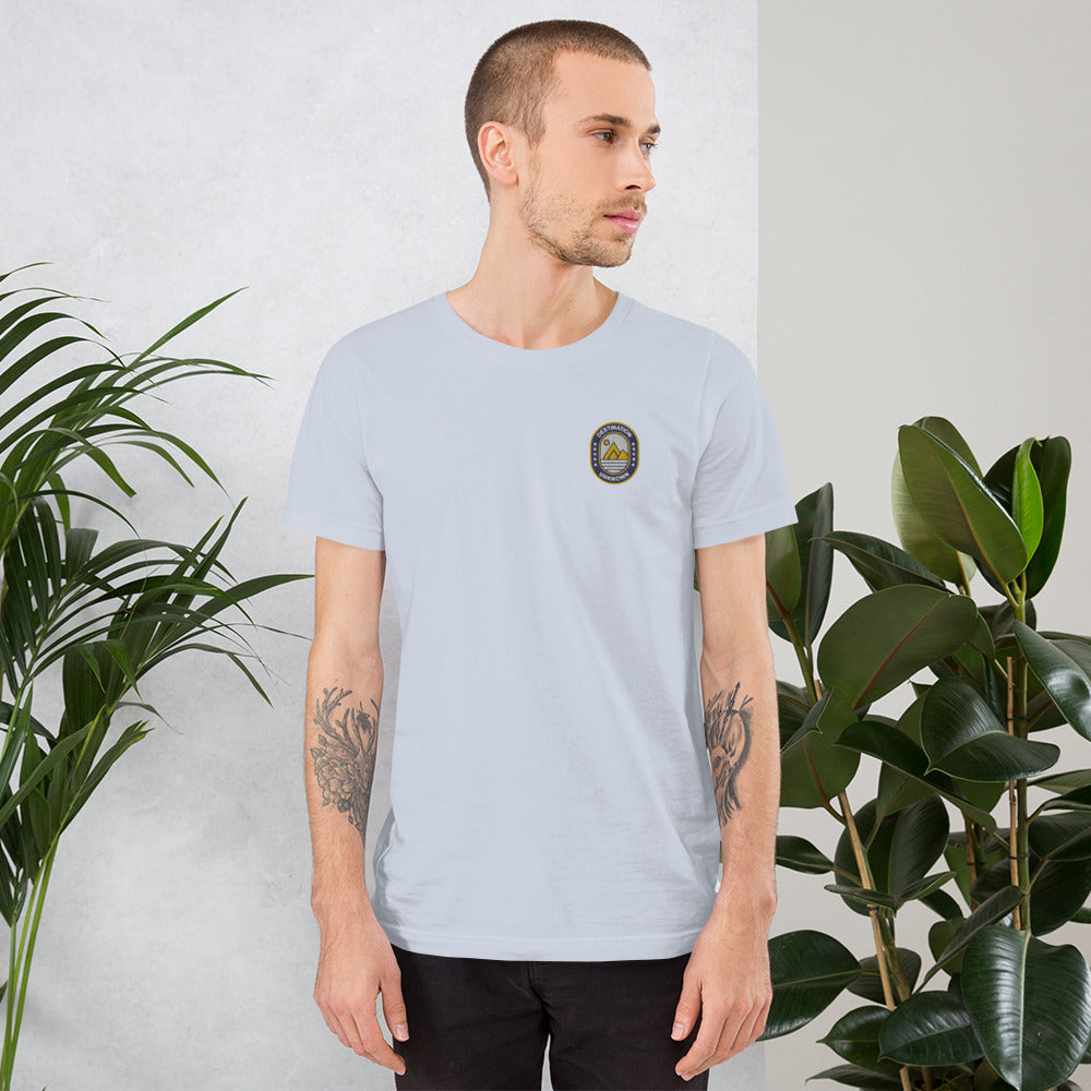 Man wearing NOMADA Mountain & Sun Camper Patch embroidered T-shirt, Light Blue color shirt