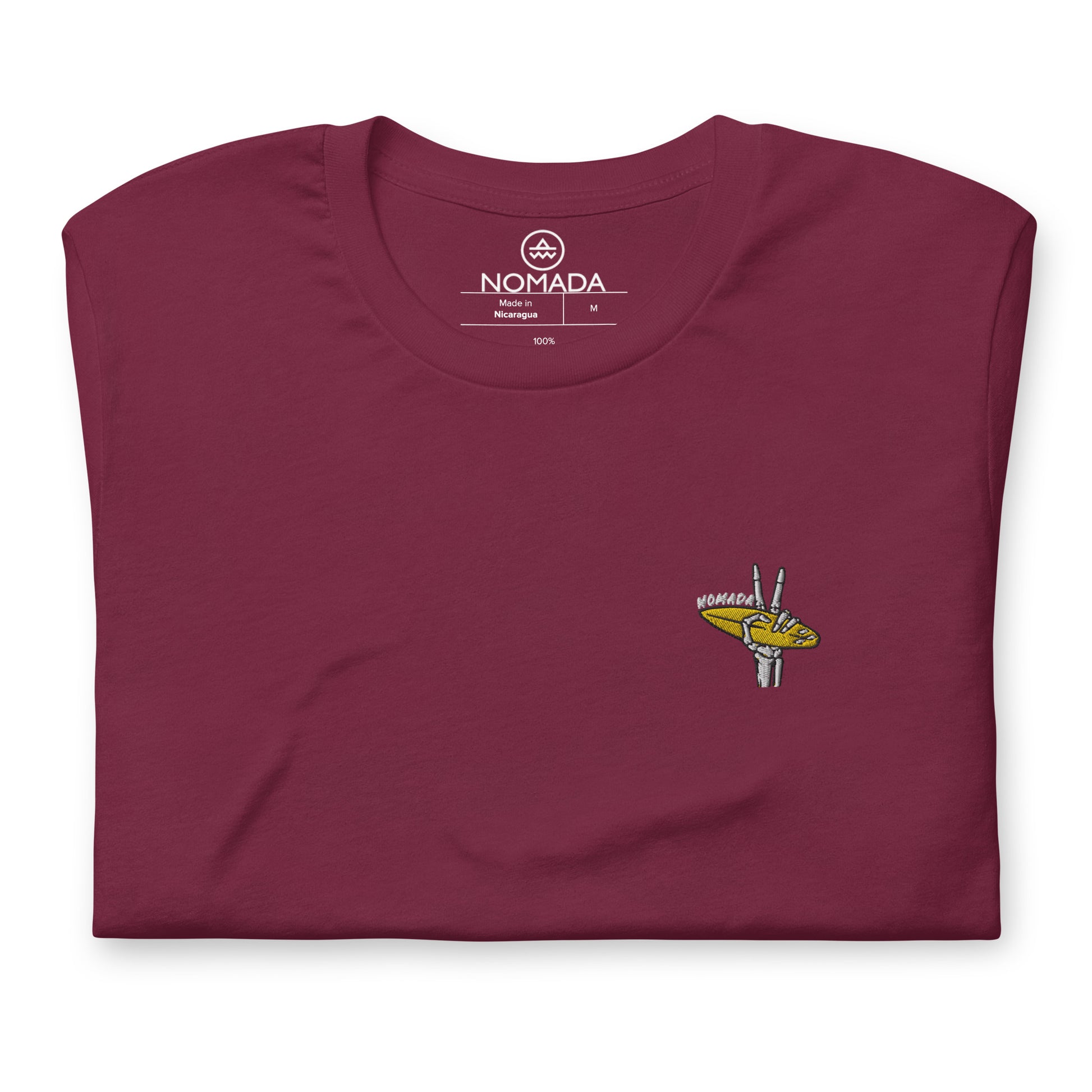 NOMADA Skeleton Hand Showing Peach Sign while holding a Surfboard embroidered T-Shirt, Maroon color shirt